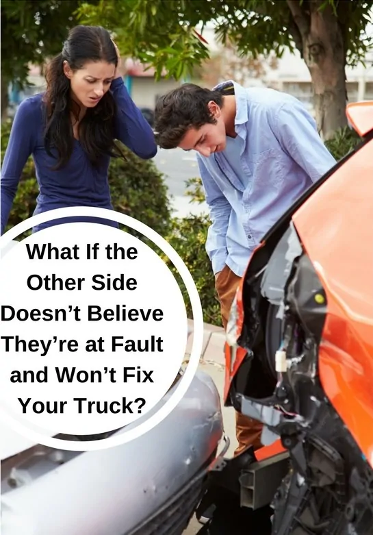 Man and woman looking at car accident damage.