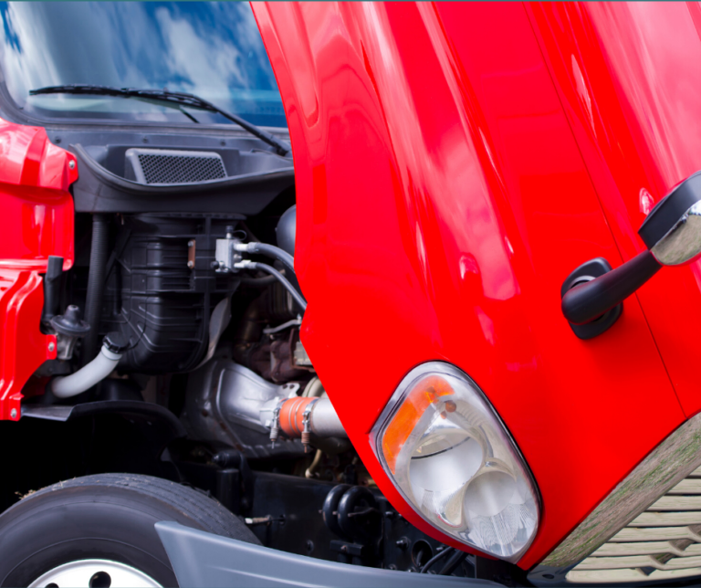 Open hood of bright red semi-truck.