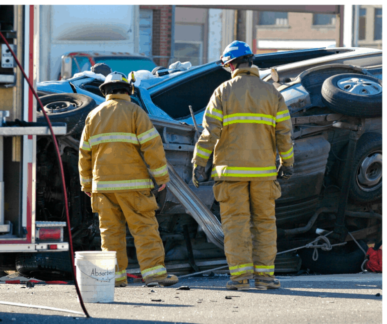 Firefighters observing automobile accident.