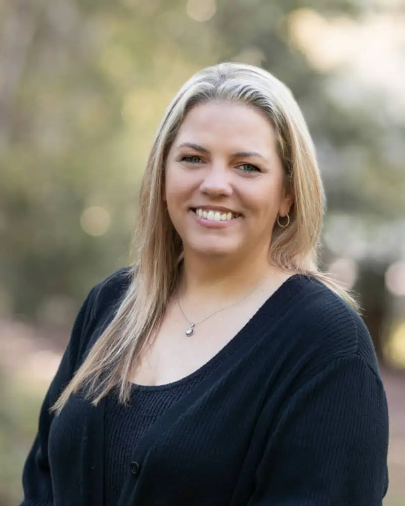 A smiling woman wearing a black sweater.